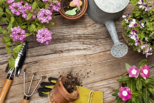 Gardener working in a residential Chessington garden preparing beds